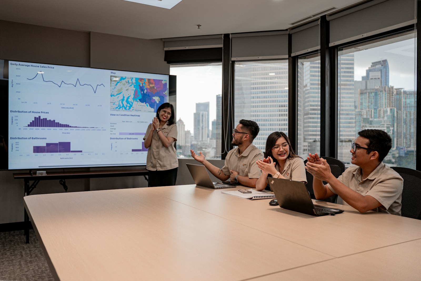 Professional team analyzing information on screens and reports